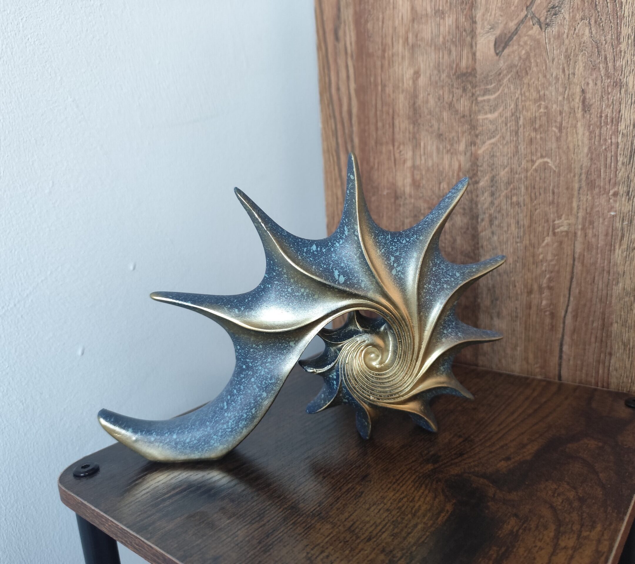 Close-up detail of the AUREA seashell ornament and its sculptural design
