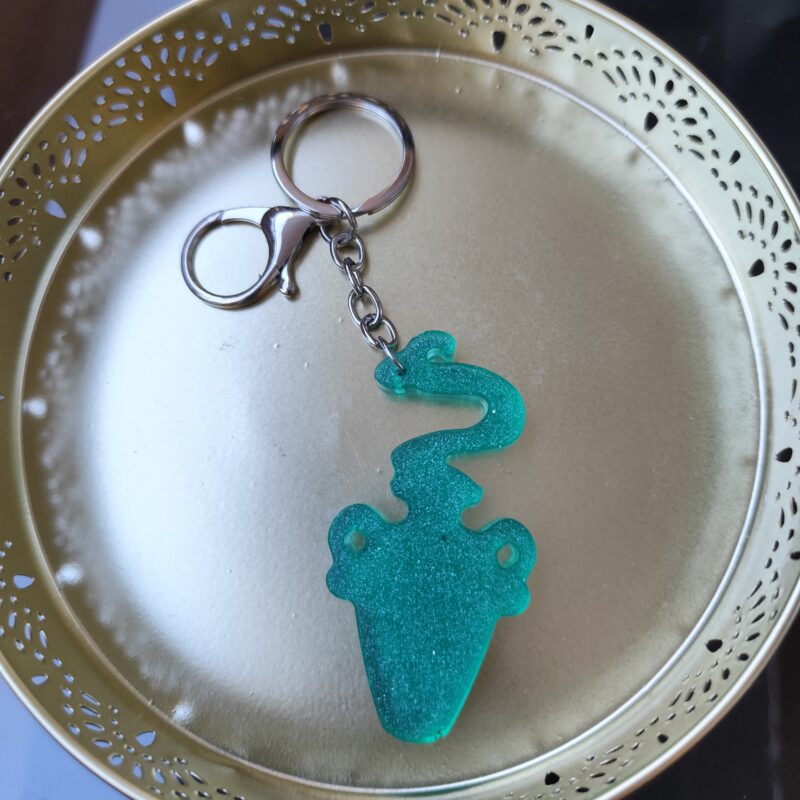 Handmade Aquarius zodiac Water Bearer keychain in green epoxy resin with glitter