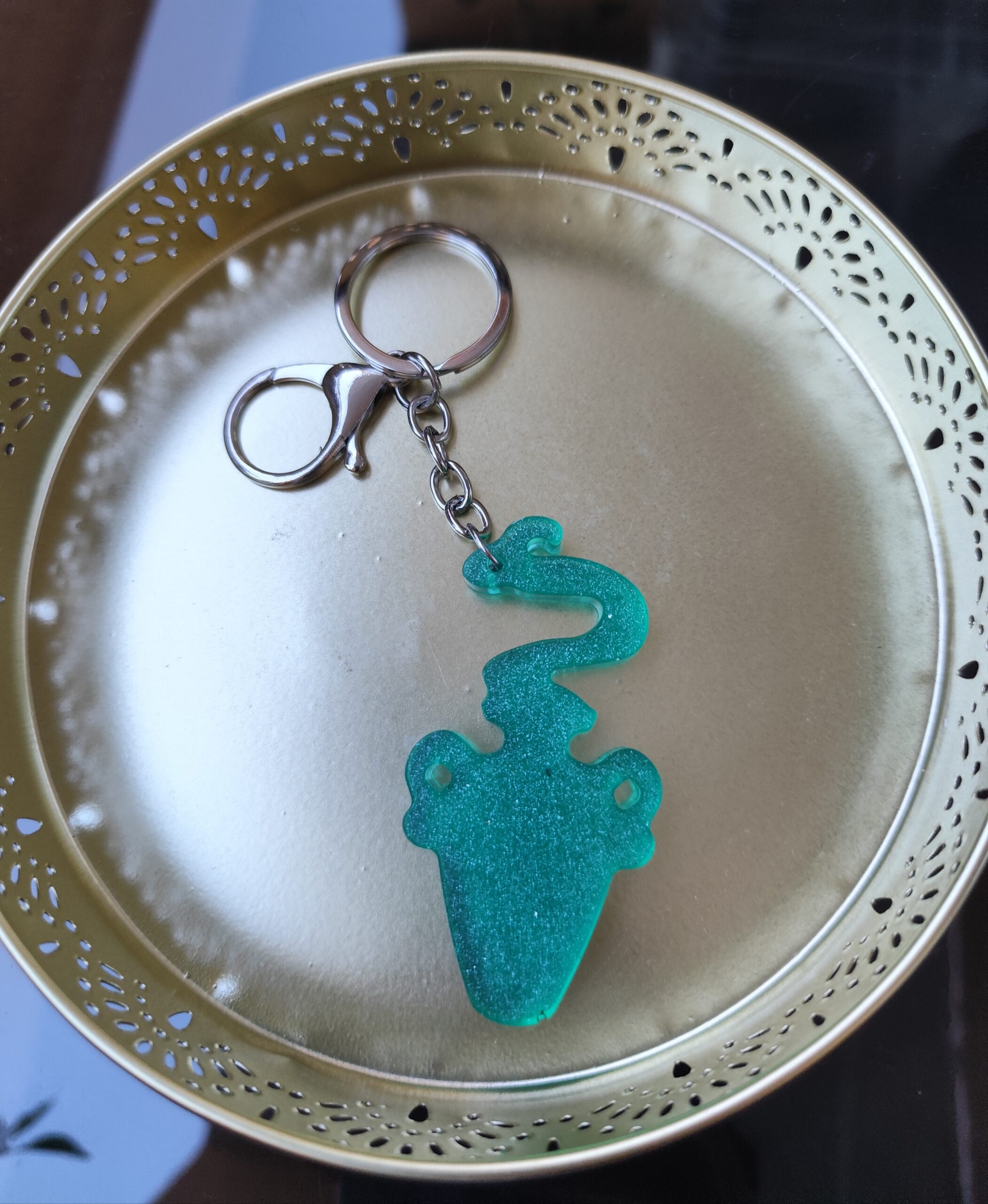Handmade Aquarius zodiac Water Bearer keychain in green epoxy resin with glitter