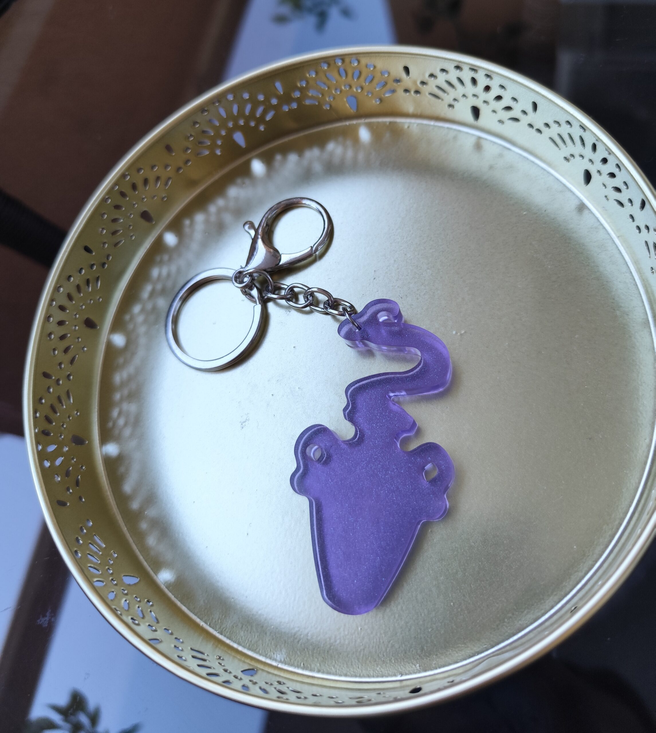 Handmade Aquarius zodiac Water Bearer keychain in purple epoxy resin