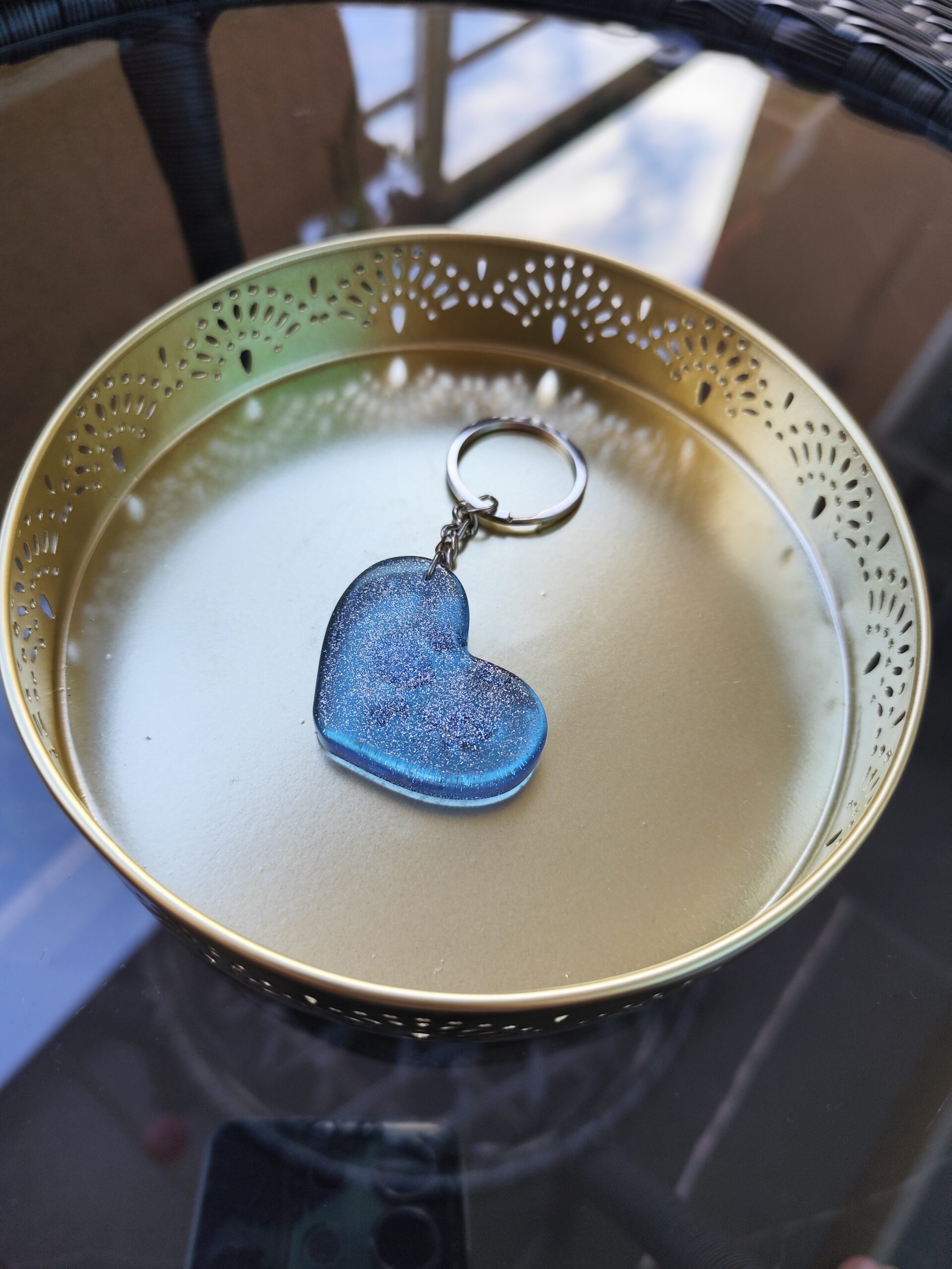 Handmade blue epoxy resin heart keychain with sparkling details and metal keyring