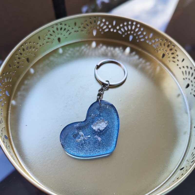 Blue handmade epoxy resin heart keyring with glitter and embedded decorative elements