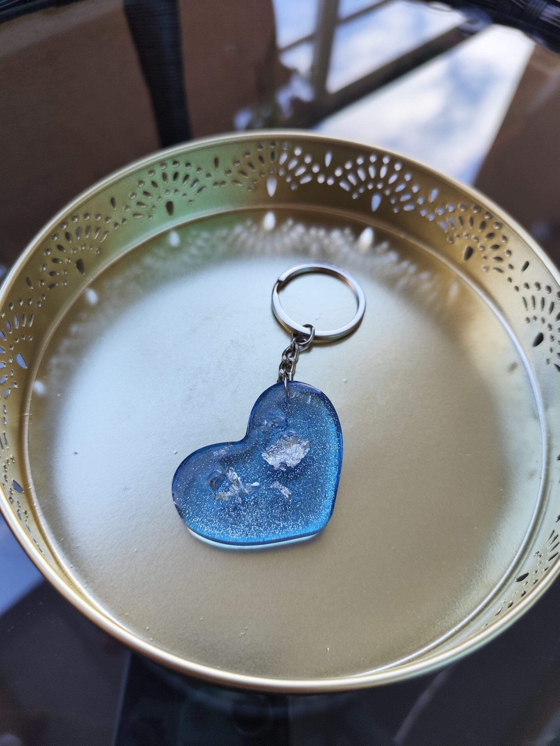 Blue handmade epoxy resin heart keyring with glitter and embedded decorative elements