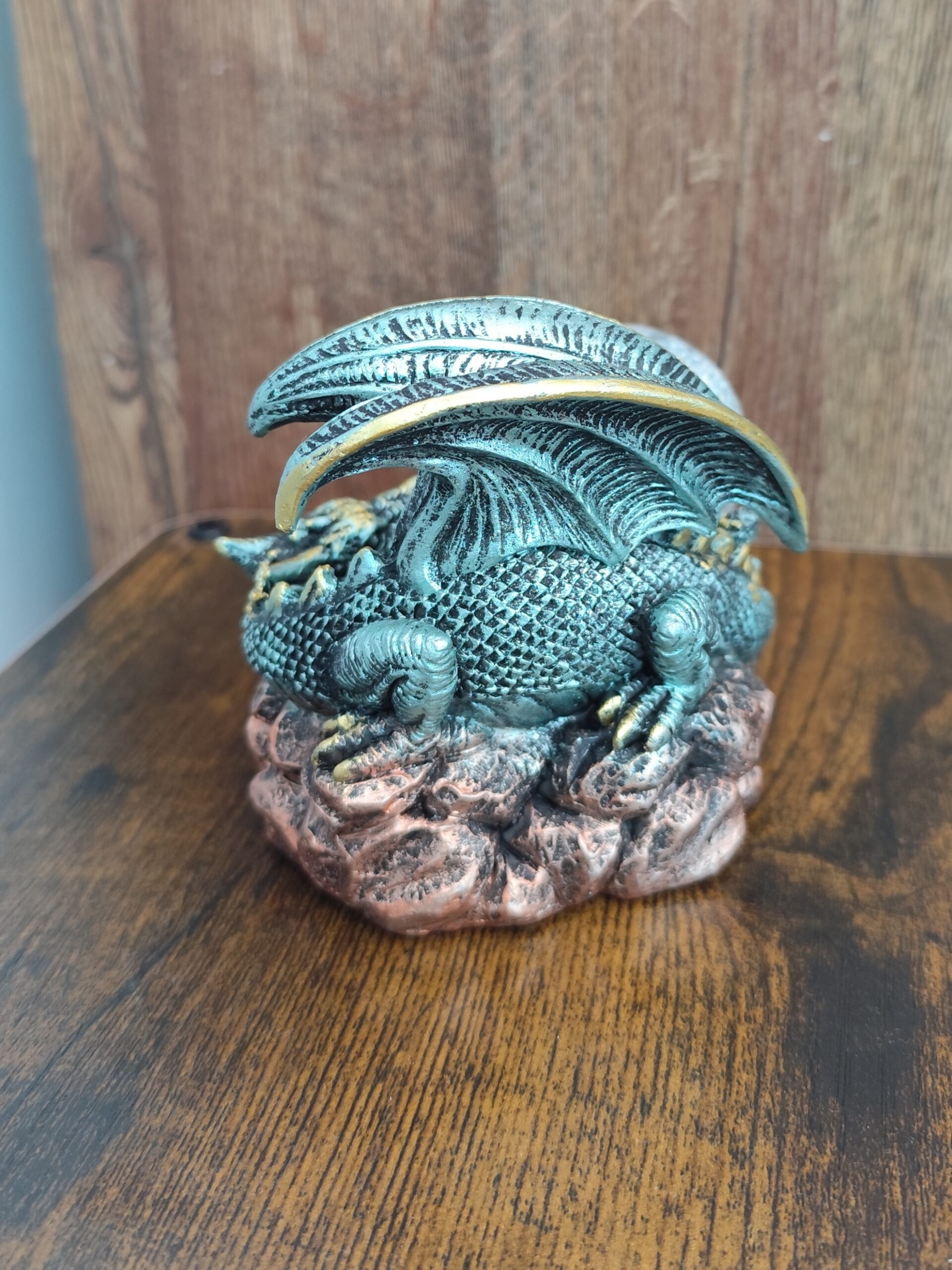 Close-up of detailed resin dragon figurine with antique gold accents