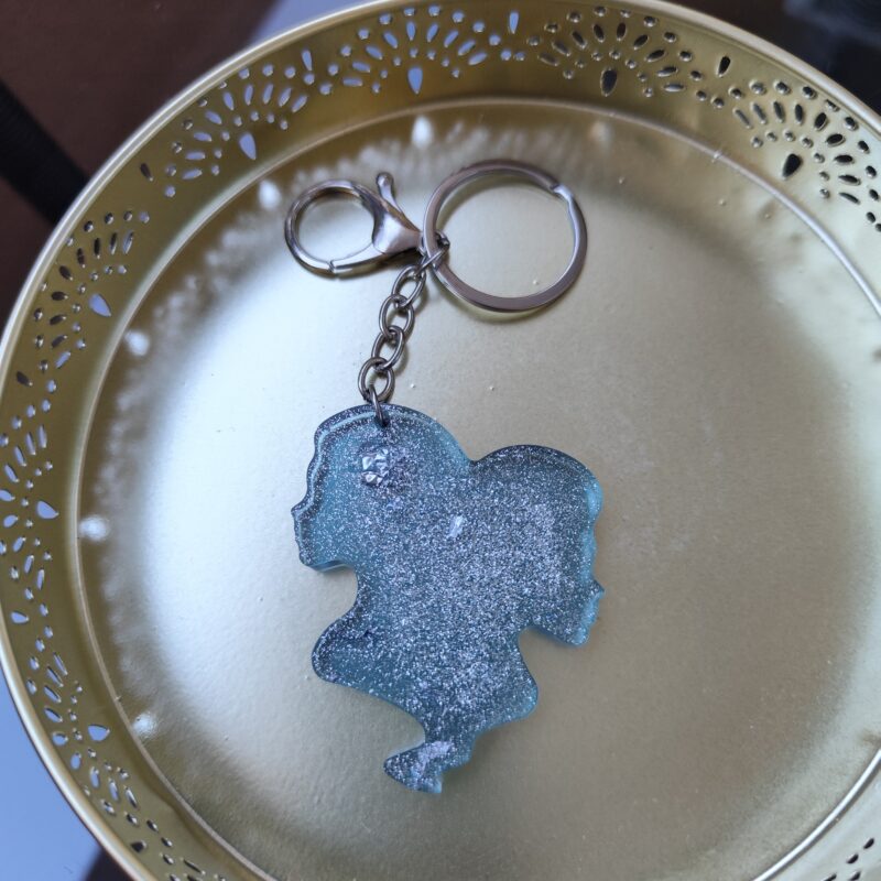 Handmade Gemini zodiac Twins keychain in light blue epoxy resin with silver glitter