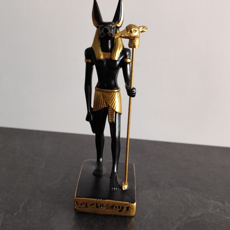 Black and gold Egyptian Anubis statue with jackal head and staff