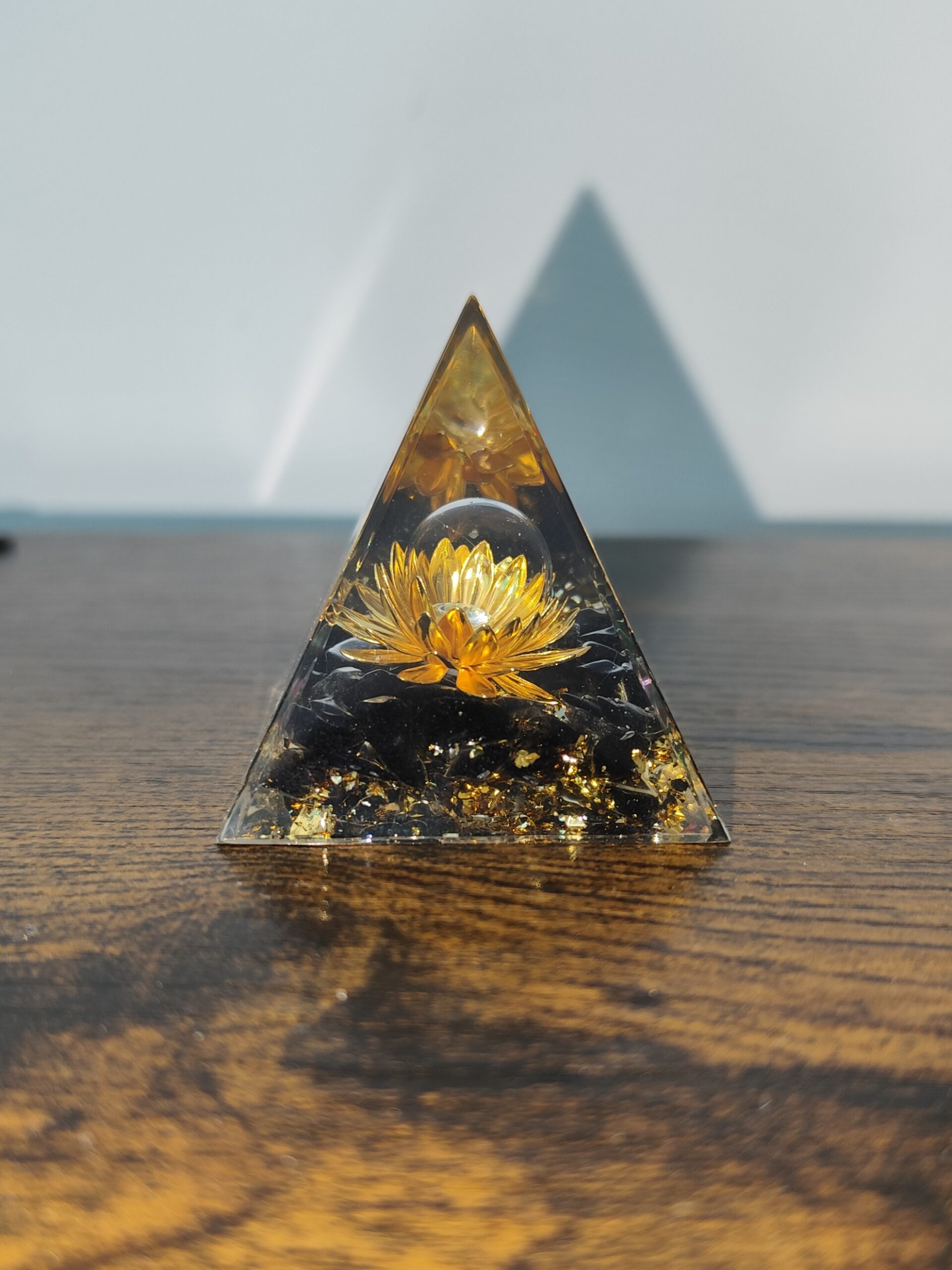 Golden Lotus orgonite pyramid with natural obsidian and metallic accents, handmade in resin