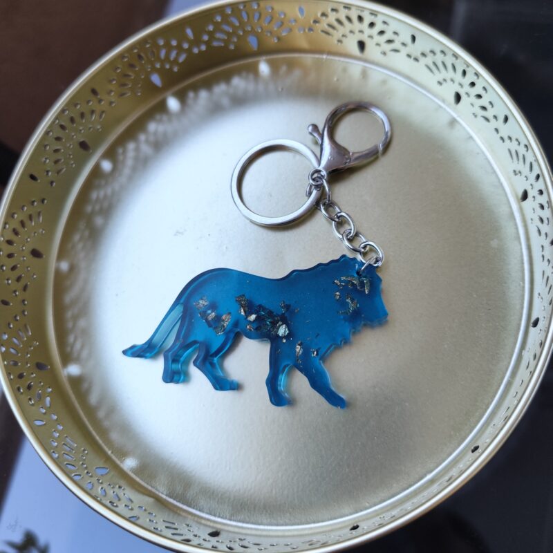 Handmade Leo zodiac lion keychain in dark blue epoxy resin with gold glitter