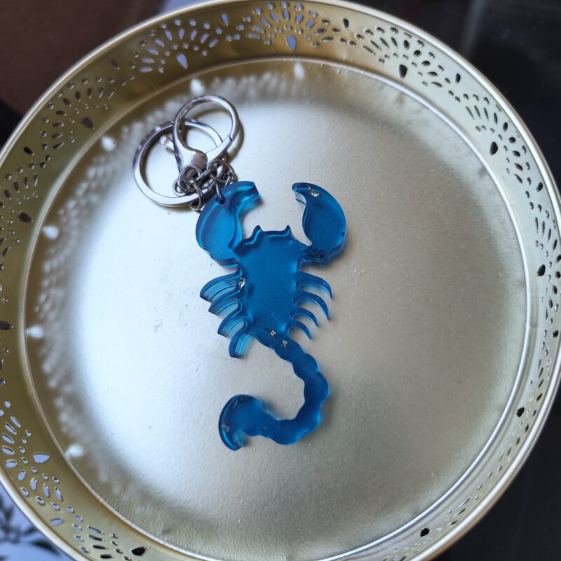 Handmade Scorpio zodiac scorpion keychain in dark blue epoxy resin with gold glitter