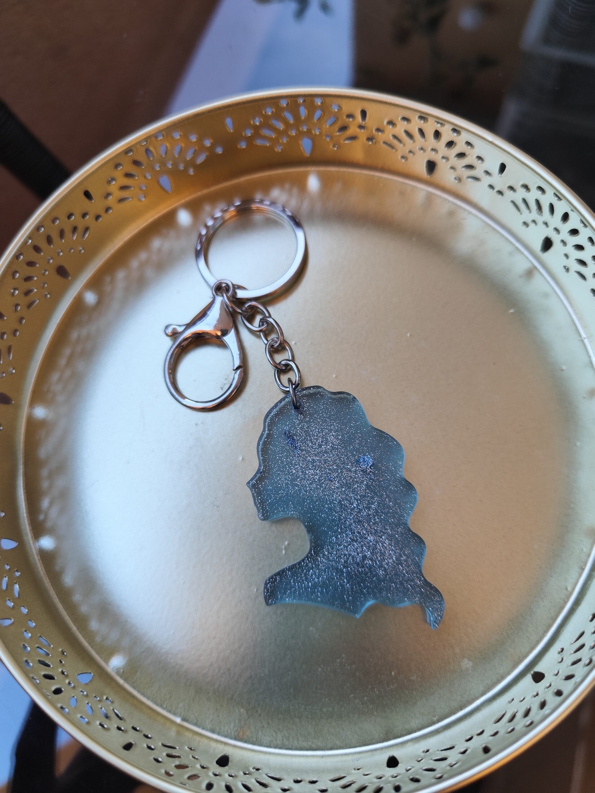 Handmade Virgo zodiac keychain in light blue epoxy resin with silver glitter